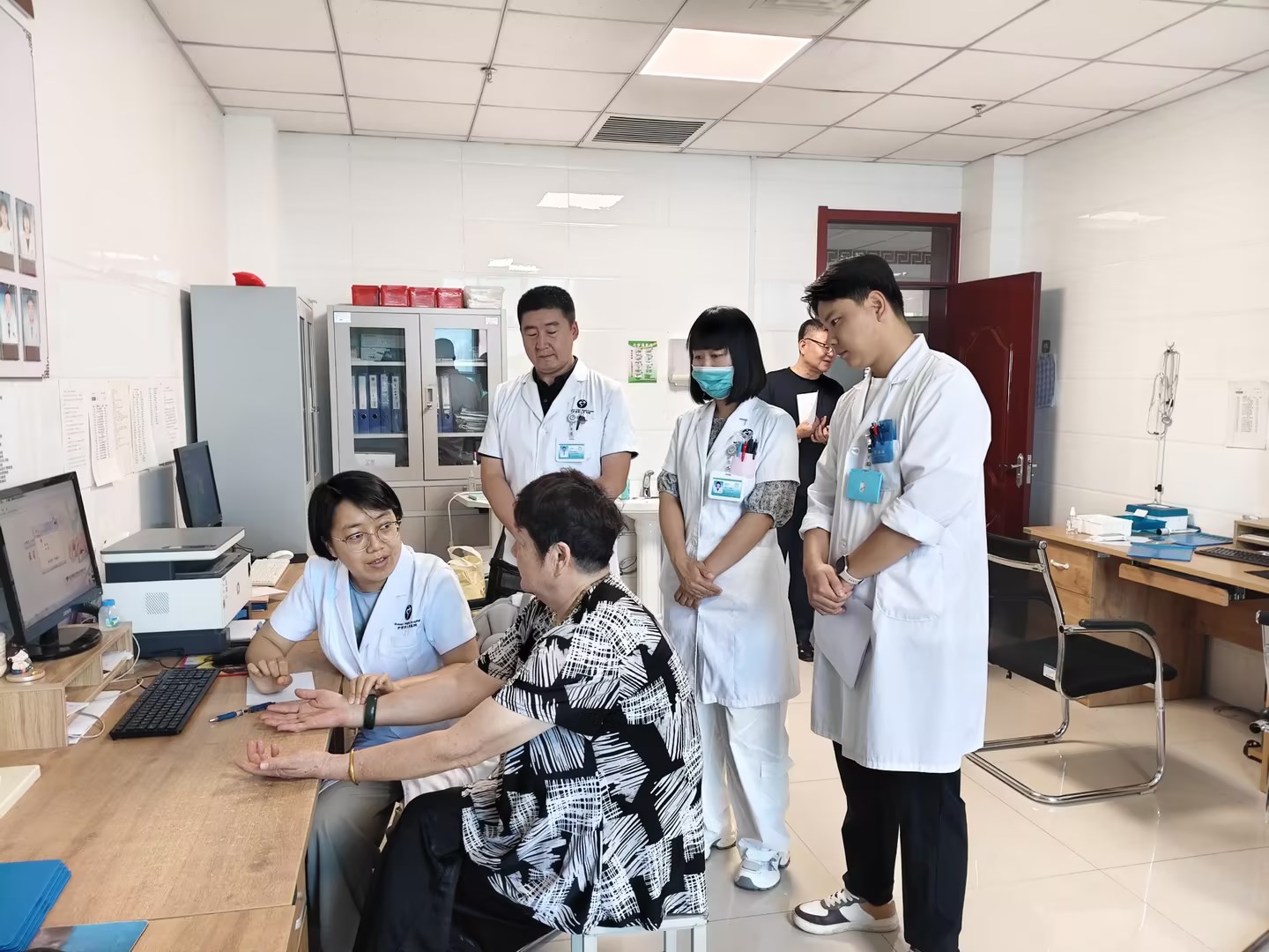 郭振（左一）在为患者问诊。